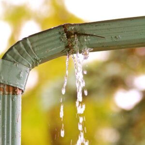 a gutter leaking from a rusty spot