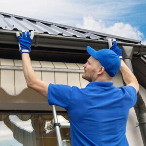 a worker holding up a gutter