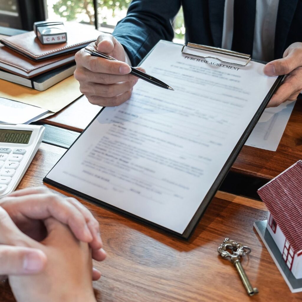 Person reviewing a property purchase agreement