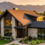 A modern Colorado home with a newly installed shingle roof during a golden sunset, showing pristine craftsmanship.